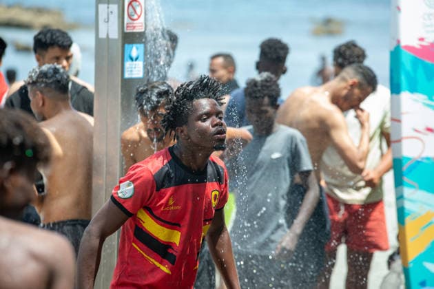 August 1, 2026, Ceuta, Ceuta, Spain: A group of migrants use beach showers near the Temporary Stay Centre for Immigrants Ceuta Spain - ZUMAd308 20260801_zsp_d308_082 Copyright: xJuanxCarlosxLucasx