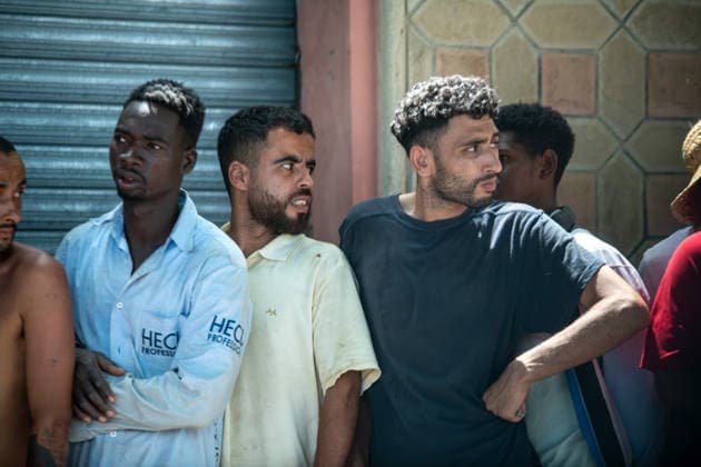 August 1, 2026, Ceuta, Ceuta, Spain: A group of migrants queue outside a small supermarket near the Temporary Stay Centre for Immigrants Ceuta Spain - ZUMAd308 20260801_zsp_d308_101 Copyright: xJuanxCarlosxLucasx