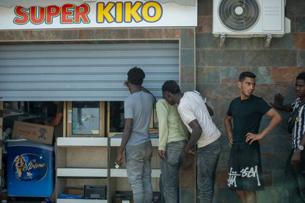 August 1, 2026, Ceuta, Ceuta, Spain: A group of migrants queue outside a small supermarket near the Temporary Stay Centre for Immigrants Ceuta Spain - ZUMAd308 20260801_zsp_d308_104 Copyright: xJuanxCarlosxLucasx
