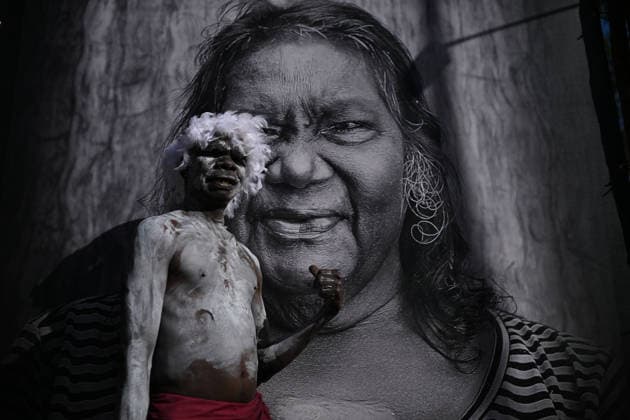 GARMA FESTIVAL, Ian Gurruwiwi, senior leader of the Galpu Clan poses for a photo with an image of his aunt Ranyjupi Yunupingu during the 26th annual Garma Festival in Gulkula, Northern Territory, Saturday, August 1, 2026. The Garma Festival takes place on the remote northeast Arnhem Land, celebrating Yolngu culture and customs in a four-day event hosted by the Yothu Yindi Foundation. ( NO ARCHIVING - VISUALS FROM THE YYF GARMA 26TH ANNIVERSARY ARE STRICTLY FOR NEWS AND CURRENT AFFAIRS COVERAGE ONLY. VISUALS MUST NOT BE USED FOR PROMOTIONAL, ADVERTISING, COMMERCIAL, FUNDRAISING OR ANY OTHER PURPOSE Gulkula Ceremonial Site Northern Territory Australia  Copyright: xJamesxRossx 20260802164634667961