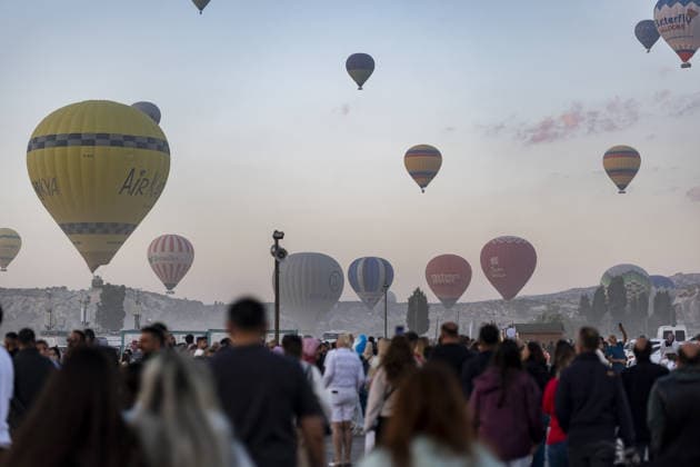 Cappadocia Balloon Festival concludes with colorful scenes NEVSEHIR, TURKIYE - AUGUST 2: People visit as ballons glide through during the 7th Cappadocia Balloon Festival concluded with the participation of 30 special-shaped hot air balloons brought from Turkiye and abroad in Nevsehir, Turkiye, on August 2, 2026. As part of the festival, sunrise demonstration flights over Goreme featured heart, owl, parrot, rocket, and globe-shaped balloons, creating colorful scenes above the region s iconic fairy chimneys and attracting the attention of both local and international visitors. Osmancan Gurdogan Anadolu Nevsehir Turkey. Editorial use only. Please get in touch for any other usage.  Copyright: x2026xAnadoluxOsmancanxGurdoganx