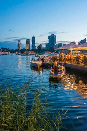 Lichterlfest (Lichterfest, Festival of Lights) at oxbow lake Alte Donau (Old Danube), illuminated boats, high-rises of Donaucity, floating restaurant Strandcafe Vienna 22. Donaustadt Wien Austria