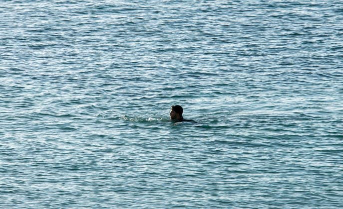 August 2, 2026, Ceuta, Madrid, Spain: A migrant attempts to swim across the border under the watchful eye of the Spanish Civil Guard at El Tarajal beach in Ceuta, Spain, August 2, 2026. Ceuta Spain - ZUMAd308 20260802_zsp_d308_001 Copyright: xJuanxCarlosxLucasx