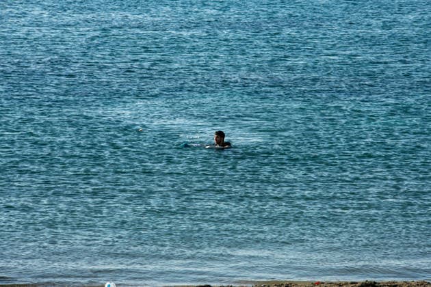 August 2, 2026, Ceuta, Madrid, Spain: A migrant attempts to swim across the border under the watchful eye of the Spanish Civil Guard at El Tarajal beach in Ceuta, Spain, August 2, 2026. Ceuta Spain  - ZUMAd308 20260802_zsp_d308_003 Copyright: xJuanxCarlosxLucasx