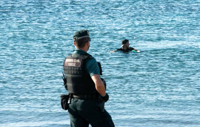 August 2, 2026, Ceuta, Madrid, Spain: A migrant attempts to swim across the border under the watchful eye of the Spanish Civil Guard at El Tarajal beach in Ceuta, Spain, August 2, 2026. Ceuta Spain - ZUMAd308 20260802_zsp_d308_005 Copyright: xJuanxCarlosxLucasx