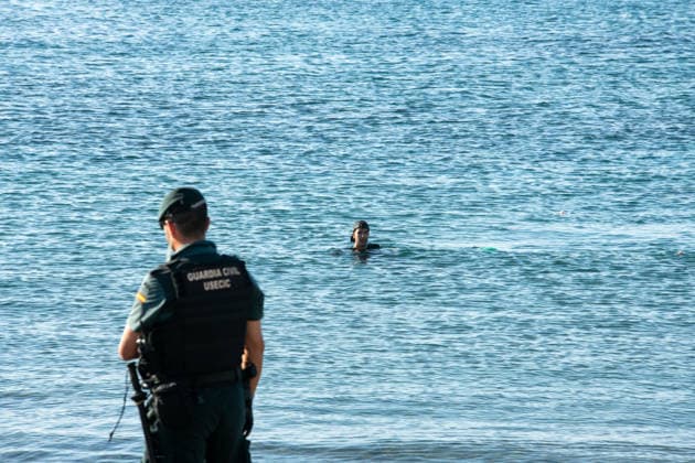 August 2, 2026, Ceuta, Madrid, Spain: A migrant attempts to swim across the border under the watchful eye of the Spanish Civil Guard at El Tarajal beach in Ceuta, Spain, August 2, 2026. Ceuta Spain - ZUMAd308 20260802_zsp_d308_006 Copyright: xJuanxCarlosxLucasx