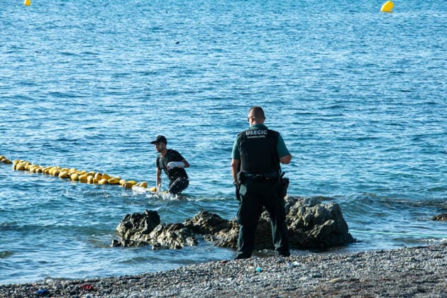 August 2, 2026, Ceuta, Madrid, Spain: A migrant attempts to swim across the border under the watchful eye of the Spanish Civil Guard at El Tarajal beach in Ceuta, Spain, August 2, 2026. Ceuta Spain - ZUMAd308 20260802_zsp_d308_018 Copyright: xJuanxCarlosxLucasx