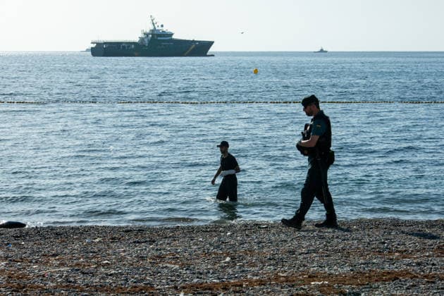 August 2, 2026, Ceuta, Madrid, Spain: A migrant attempts to swim across the border under the watchful eye of the Spanish Civil Guard at El Tarajal beach in Ceuta, Spain, August 2, 2026. Ceuta Spain - ZUMAd308 20260802_zsp_d308_023 Copyright: xJuanxCarlosxLucasx