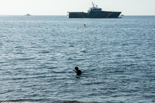 August 2, 2026, Ceuta, Madrid, Spain: A migrant attempts to swim across the border under the watchful eye of the Spanish Civil Guard at El Tarajal beach in Ceuta, Spain, August 2, 2026. Ceuta Spain - ZUMAd308 20260802_zsp_d308_031 Copyright: xJuanxCarlosxLucasx