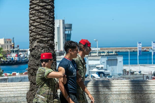 August 2, 2026, Ceuta, Madrid, Spain: Military personnel and police officers escort a group of Moroccan migrants toward the border with Morocco in the Spanish enclave of Ceuta, Spain, August 2, 2026. Armed forces and national police have begun rounding up and escorting the remaining migrants who entered irregularly during a massive migration crisis in recent days, allowing the city s streets and shops to return to normalcy. Ceuta Spain - ZUMAd308 20260802_zsp_d308_114 Copyright: xJuanxCarlosxLucasx