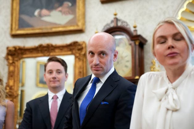 Deputy Chief of Staff Stephen Miller looks on as President Donald Trump announces an executive order establishing the Presidential Military Spouse Commission in the Oval Office at the White House in Washington, DC on Monday, August 3, 2026. The advisory board, led by Jennifer Hegseth, wife of Secretary of Defense Pete Hegseth, will focus on key quality-of-life areas for military families including employment, childcare, housing, healthcare, and education.  WASP20260803118 AllisonxRobbert