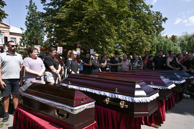 People pay their last respects to members of the Voronov family, killed when a Russian Iskander-M ballistic missile directly struck their home on the night of Thursday, July 30, Radushne settlement, Kryvyi Rih district, Dnipropetrovsk region, Ukraine, August 3, 2026. Five family members whose identities have been officially confirmed were laid to rest: parents Artem, 47, and Olena, 41, together with their children Mark, 17, Azarii Ilai, 11, and Emiliia, 6. Five other children who were in the house that night - Zakhar, Dominika, Viorika, Federika and one-and-a-half-year-old grandson Artem - are still officially listed as missing. Rescuers recovered 17 body fragments from the rubble, and complex forensic DNA examinations are under way to iden  Copyright: xDmytroxSmolienkox