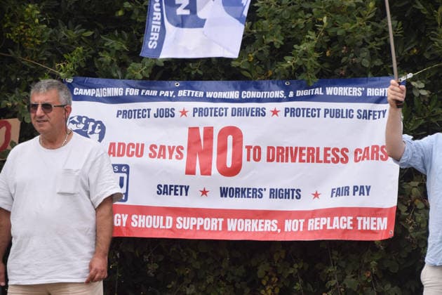 August 4, 2026, London, England, United Kingdom: Members of the App Drivers and Couriers Union (ADCU) gather outside the Waymo depot in Park Royal in protest against Waymo driverless cars. London United Kingdom  - ZUMAv130 20260804_zip_v130_006 Copyright: xVukxValcicx