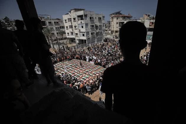 Palestinians Hold Mass Funeral for 112 Members of Two Families in Gaza GAZA CITY, PALESTINE August 4, 2026: Palestinians carry the remains of 112 members of the Al-Hassaina and Abu Sharia families during a mass funeral procession in the Al-Sabra neighborhood of Gaza City on August 4, 2026. The victims were killed in separate Israeli attacks during the war that began on October 7, 2023, and their bodies were recovered from beneath the rubble months later. According to local authorities, the procession was among the largest funeral processions held in the Gaza Strip since the beginning of the war. Gaza Palestine, State of Copyright: x xMohammedxMxSkaikx xJNAxPressx