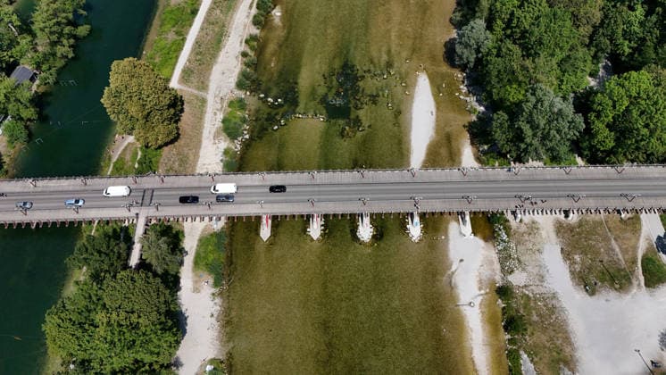 Ein Sommertag in der Landeshauptstadt München. Hier der Blick auf die Thalkirchner Brücke, Straßenbrücke über die Isar und den parallel verlaufenden Isar-Werkkanal wird ab 2027 für 2 Jahre gesperrt, wegen Sanierung, Instalthaltung, Stau, Umfahrung, Stadtviertel, Tierpark, Anwohner aufgebracht *** A summer day in Munich, the state capital. Here is a view of the Thalkirchner Bridge, a road bridge over the Isar River and the parallel Isar Werkkanal, which will be closed for two years starting in 2027 due to renovation, maintenance, traffic congestion, detours, neighborhoods, the zoo, and frustrated residents
