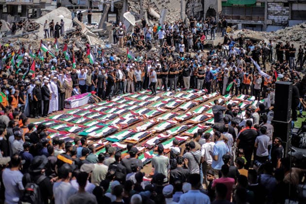 Palestinians Hold Mass Funeral For 112 Family Members In Gaza - Palestine A photograph shows the flag-covered remains of members of the Abu Sharia and al-Hasayna families, recently recovered from the rubble of residential buildings in the al-Sabra neighbourhood which were struck by Israeli bombardments in November 2023, during a mass funeral in Gaza City on August 4, 2026. An October ceasefire remains in place between Israel and Hamas, but it has not halted the violence in Gaza. Photo by Photo by Rizek ELdremle ABACAPRESS.COM Gaza City Palestine  Copyright: xEldremlexRizek ABACAx