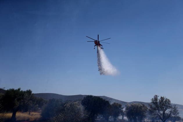 August 5, 2026, Koropi, Greece: Firefighters battle a wildfire in the Koropi area, southeast of Athens, as helicopters carry out repeated water drops to contain the flames. Ground crews worked alongside aerial firefighting units to prevent the fire from spreading amid dry conditions and strong winds. Koropi Greece  - ZUMAv62_ 20260805_zaf_v62_021 Copyright: xAristidisxVafeiadakisx