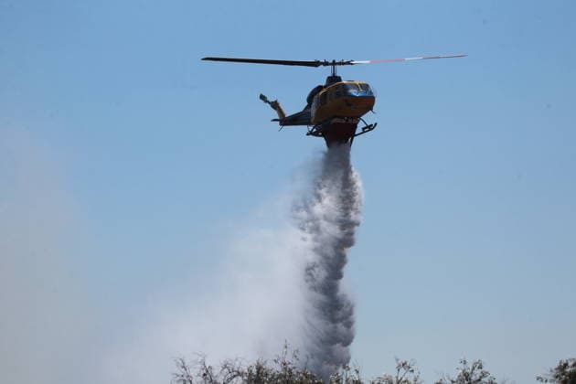 August 5, 2026, Koropi, Greece: Firefighters battle a wildfire in the Koropi area, southeast of Athens, as helicopters carry out repeated water drops to contain the flames. Ground crews worked alongside aerial firefighting units to prevent the fire from spreading amid dry conditions and strong winds. Koropi Greece  - ZUMAv62_ 20260805_zaf_v62_069 Copyright: xAristidisxVafeiadakisx