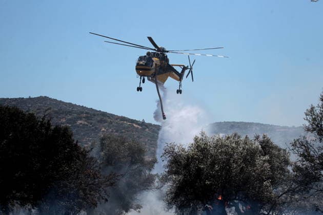 August 5, 2026, Koropi, Greece: Firefighters battle a wildfire in the Koropi area, southeast of Athens, as helicopters carry out repeated water drops to contain the flames. Ground crews worked alongside aerial firefighting units to prevent the fire from spreading amid dry conditions and strong winds. Koropi Greece - ZUMAv62_ 20260805_zaf_v62_053 Copyright: xAristidisxVafeiadakisx