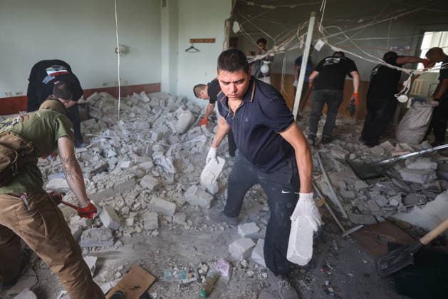 RUSSIA, DONETSK - AUGUST 5, 2026: Local residents clear the debris in a gastroenterology ward of Donetsk City Clinical Hospital No 7 following a Ukrainian drone strike. The attack left one patient dead and two others injured. Dmitry Yagodkin TASS  95820408