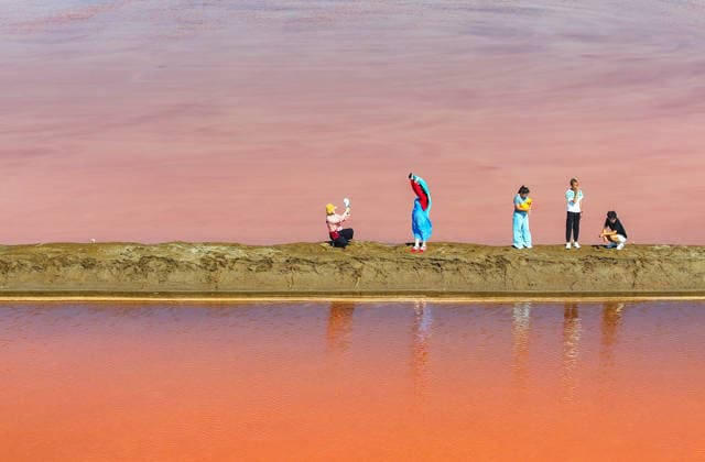 (260805) -- ORDOS, Aug. 5, 2026 -- A drone photo taken on Aug. 5, 2026 shows tourists having fun at a salt lake in Otog Front Banner in the city of Ordos, north China s Inner Mongolia Autonomous Region. (Photo by Xinhua) CHINA-INNER MONGOLIA-ORDOS-SALT LAKE-SCENERY (CN) WangxZheng 