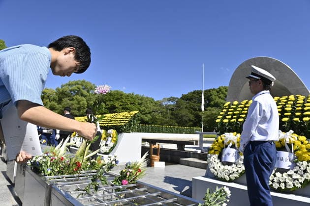 Japan marks 81st anniversary of the atomic bombing of Hiroshima HIROSHIMA, JAPAN - AUGUST 6 : A visitor offers a flower in front of the cenotaph for atomic bomb victims at Peace Memorial Park following the Hiroshima Peace Memorial Ceremony in Hiroshima, Japan, on August 6, 2026. Japan marks the 81st anniversary of the atomic bombing of Hiroshima. David Mareuil Anadolu Hiroshima Japan. Editorial use only. Please get in touch for any other usage.  Copyright: x2026xAnadoluxDavidxMareuilx