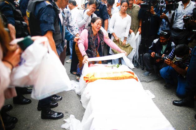 August 6, 2027, Kathmandu, Nepal: Relatives mourn over the coffin containing the body of renowned Nepali mountaineer Pur Bahadur Gurung (Yukta) at Tribhuvan International Airport. Vice President of the Nepal Mountaineering Association, Gandaki Province, was among the climbers killed in an avalanche on Broad Peak in Pakistan and was the first victim to be recovered from the avalanche site. Kathmandu Nepal  - ZUMAs197 20270806_aaa_s197_007 Copyright: xSkandaxGautamx
