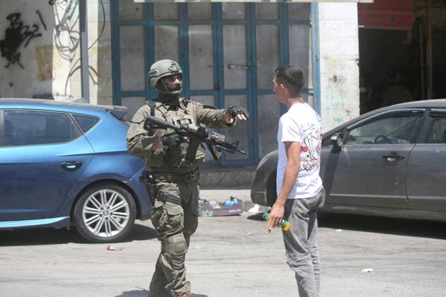 August 6, 2026, Nablus, Palestine: An Israeli soldier stops a Palestinian boy during a military operation in neighborhoods of the Askar refugee camp east of Nablus in the West Bank. The raid is part of a broader military campaign targeting refugee camps in the West Bank. The Israeli government has threatened to occupy refugee camps, in areas under the control of Palestinian President Mahmoud Abbas. Nablus Palestine - ZUMAs197 20260806_aaa_s197_100 Copyright: xNasserxishatyehx