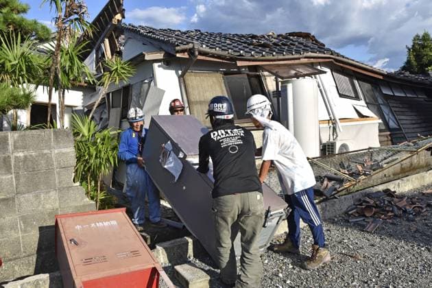 Aftermath of strong earthquake in Kumamoto Volunteers carry a refrigerator out of a collapsed house in Hikawa, Kumamoto Prefecture, on Aug. 5, 2026, after a powerful earthquake struck the southwestern Japan prefecture on July 28.  A14AA0005625308P