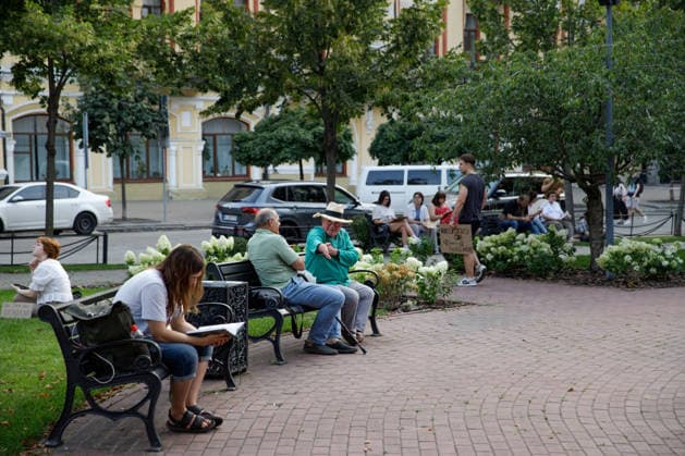 People sit on benches in a park during a peaceful protest against the dismissal of Mykhailo Fedorov from the post of Ukraine’s Defence Minister in Ivana Franka Square outside the Ivan Franko National Academic Drama Theatre, close to the Office of the President, Kyiv, Ukraine, August 6, 2026. Large-scale cardboard rallies in support of former Defence Minister Mykhailo Fedorov have been held in Kyiv and other cities across Ukraine for 22 consecutive days. On 14 July 2026, the Ukrainian Parliament accepted the resignation of Prime Minister Yuliia Svyrydenko, leading to the resignation of the Cabinet. On 15 July 2026, President Volodymyr Zelenskyy dismissed Defence Minister Mykhailo Fedorov, sparking widespread protests across the country. (P  Copyright: xMariannaxKotykx