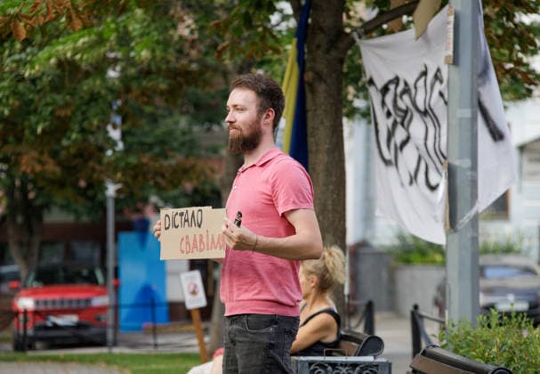 An activist holds a placard during a peaceful protest against the dismissal of Mykhailo Fedorov from the post of Ukraine’s Defence Minister in Ivana Franka Square outside the Ivan Franko National Academic Drama Theatre, close to the Office of the President, Kyiv, Ukraine, August 6, 2026. Large-scale cardboard rallies in support of former Defence Minister Mykhailo Fedorov have been held in Kyiv and other cities across Ukraine for 22 consecutive days. On 14 July 2026, the Ukrainian Parliament accepted the resignation of Prime Minister Yuliia Svyrydenko, leading to the resignation of the Cabinet. On 15 July 2026, President Volodymyr Zelenskyy dismissed Defence Minister Mykhailo Fedorov, sparking widespread protests across the country. (Photo  Copyright: xMariannaxKotykx
