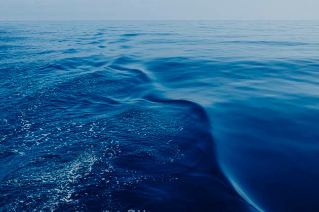 Deep blue sea water creates a wake behind a sailing boat in Ibiza, GMLF02162