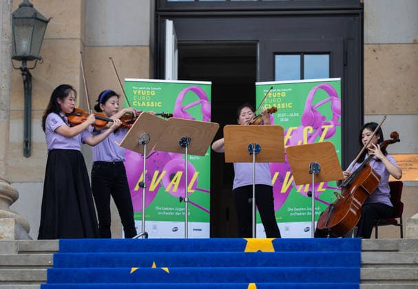 (260806) -- BERLIN, Aug. 6, 2026 -- Musicians from the Orchestra of the Zhejiang Conservatory of Music perform during a flash mob activity at the Konzerthaus Berlin in Berlin, Germany, Aug. 5, 2026. Orchestra of the Zhejiang Conservatory of Music took the stage on Wednesday at the Konzerthaus Berlin, delivered a captivating performance at the Young Euro Classic 2026. During its stay, the orchestra also staged a series of flash mob performances. ) GERMANY-BERLIN-CHINA-ORCHESTRA-PERFORMANCE ZhangxHaofu 