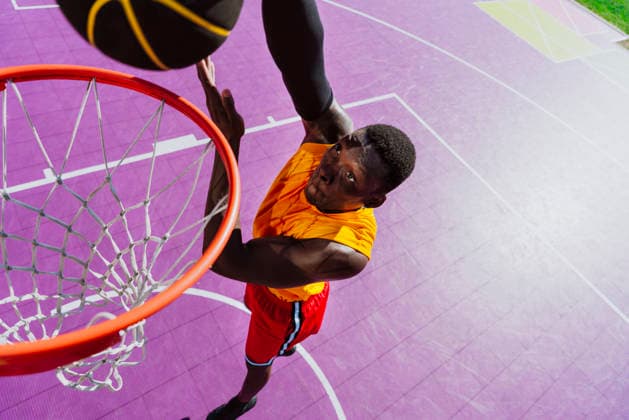Man dunks a basketball into the hoop on an outdoor court model released, Symbolfoto property released, OIPF05225