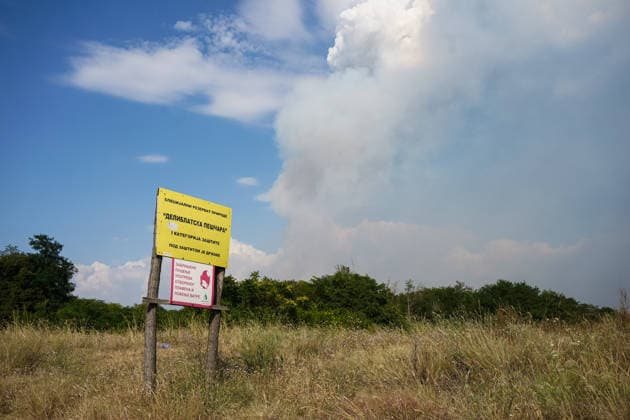 August 7, 2026, Sumarak, Vojvodina, Serbia: 202687, Sumarak, Serbia - Thick smoke rises above the landscape as a massive wildfire burns through the Deliblato Sands (Deliblatska Pescara) Special Nature Reserve. Helicopters of the Serbian Armed Forces are deployed to combat the blaze, using Bambi buckets to fetch water and extinguish the fire from the air. Deliblato Sands, often referred to as the European Sahara, is a strictly protected natural area. Sumarak Serbia  - ZUMAd223 20260807_zip_d223_009 Copyright: xMarkoxDimicx