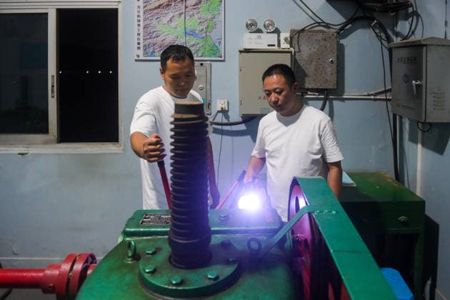 (260808) -- WENZHOU, Aug. 8, 2026 -- Staff members check the water level and prepare for drainage at a sluice along the Qingjiang River in Leqing, Wenzhou, east China s Zhejiang Province, Aug. 8, 2026. Coastal areas of eastern China were bracing for strong winds and torrential rain as Typhoon Dolphin approached, prompting authorities to recall fishing boats, suspend ferry services and prepare for evacuations. China s meteorological authority on Saturday upgraded its emergency response for Dolphin to Level III and raised the typhoon warning from yellow to orange. ) CHINA-ZHEJIANG-TYPHOON DOLPHIN-PREVENTION (CN) JiangxHan 