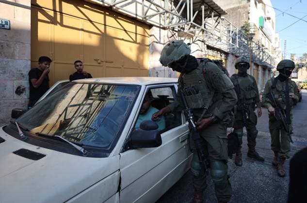 August 8, 2026, Hebron, Palestine, State of: HEBRON, Palestine Ã¢â‚¬ August 8, 2026: A Palestinian family sits inside their vehicle after it was stopped during a settler incursion in the Old City of Hebron, as Israeli forces secure the area. The incident occurred amid heightened tensions and increased settler activity in the historic city. Hebron Palestine, State of  - ZUMAq101 20260808_zna_q101_081 Copyright: xMosabxShawerx