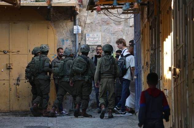 August 8, 2026, Hebron, Palestine, State of: HEBRON, Palestine Ã¢â‚¬ August 8, 2026: A Palestinian family sits inside their vehicle after it was stopped during a settler incursion in the Old City of Hebron, as Israeli forces secure the area. The incident occurred amid heightened tensions and increased settler activity in the historic city. Hebron Palestine, State of - ZUMAq101 20260808_zna_q101_086 Copyright: xMosabxShawerx