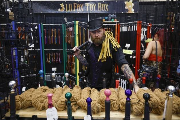 August 8, 2026, St. Petersburg, Florida, USA: Owner of Lil Fox Toy Box, Papa Shroder shows off his hand made leather paddles, whips, flogs and other BDSM accessories during the Fetish Con trade show on Saturday, Aug. 8, 2026 in St. Petersburg. St. Petersburg USA - ZUMAs70_ 20260808_zan_s70_003 Copyright: xLuisxSantanax