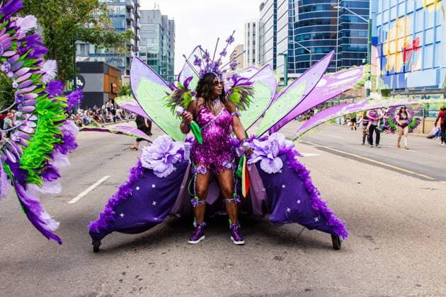 August 8, 2026, Edmonton, Alberta, Canada: Some of the Mas Band costumes are so heavy that they require rails and wheels as they danced through the center of downtown Edmonton during the Cariwest Parade on day 2 of the Cariwest Festival..Western Canada s largest Caribbean Festival, Cariwest, held its annual parade as part of its 42nd year of festivities. The Parade Mas Bands represent the various Caribbean various Islands and are dressed in brightly colored costumes, some of which can weigh up to 200 lbs, requiring wheels to support the weight. Edmonton Canada - ZUMAs197 20260808_aaa_s197_223 Copyright: xRonxPalmerx