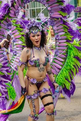 August 8, 2026, Edmonton, Alberta, Canada: Mas Band member wears a set of feathers on shoulder bars through downtown Edmonton during the Cariwest Parade on day 2 of the Cariwest Festival..Western Canada s largest Caribbean Festival, Cariwest, held its annual parade as part of its 42nd year of festivities. The Parade Mas Bands represent the various Caribbean various Islands and are dressed in brightly colored costumes, some of which can weigh up to 200 lbs, requiring wheels to support the weight. Edmonton Canada - ZUMAs197 20260808_aaa_s197_226 Copyright: xRonxPalmerx