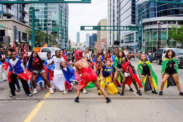 August 8, 2026, Edmonton, Alberta, Canada: One of the Mas Band stops to dance for the crowd in downtown Edmonton during the Cariwest Parade on day 2 of the Cariwest Festival..Western Canada s largest Caribbean Festival, Cariwest, held its annual parade as part of its 42nd year of festivities. The Parade Mas Bands represent the various Caribbean various Islands and are dressed in brightly colored costumes, some of which can weigh up to 200 lbs, requiring wheels to support the weight. Edmonton Canada - ZUMAs197 20260808_aaa_s197_233 Copyright: xRonxPalmerx