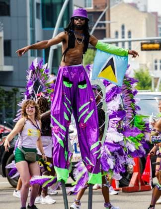 August 8, 2026, Edmonton, Alberta, Canada: A Mas Band stilt walker danced through downtown Edmonton during the Cariwest Parade on day 2 of the Cariwest Festival..Western Canada s largest Caribbean Festival, Cariwest, held its annual parade as part of its 42nd year of festivities. The Parade Mas Bands represent the various Caribbean various Islands and are dressed in brightly colored costumes, some of which can weigh up to 200 lbs, requiring wheels to support the weight. Edmonton Canada - ZUMAs197 20260808_aaa_s197_241 Copyright: xRonxPalmerx