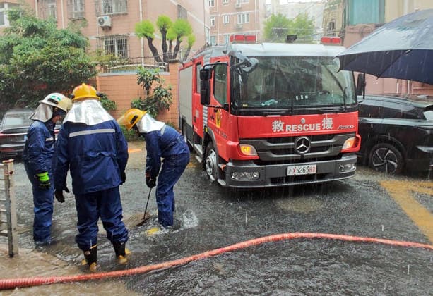 (260809) -- SHANGHAI, Aug. 9, 2026 -- Firefighters drain water at a residential area in Changning District of Shanghai, east China, Aug. 9, 2026. Shanghai experienced strong winds and rainfalls on Sunday as Typhoon Dolphin approached, with the typhoon s impact expected to last until Aug. 11. China s national observatory on Sunday activated a red alert -- the highest level in the country s typhoon warning system -- as Typhoon Dolphin approaches. Typhoon Dolphin is forecast to make landfall along the country s east coast from Zhoushan in Zhejiang Province to Fuding in Fujian Province, according to the National Meteorological Center (NMC). (Photo by Xinhua) CHINA-SHANGHAI-TYPHOON DOLPHIN-IMPACT (CN) YanxJianmeng 