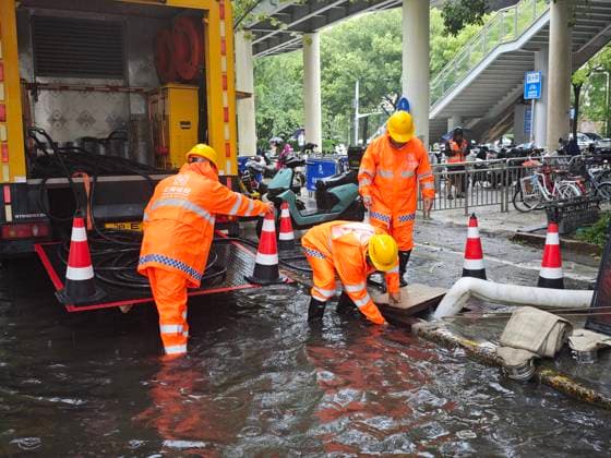 (260809) -- SHANGHAI, Aug. 9, 2026 -- Workers drain water with a drainage pump truck on a road in Xuhui District of Shanghai, east China, Aug. 9, 2026. Shanghai experienced strong winds and rainfalls on Sunday as Typhoon Dolphin approached, with the typhoon s impact expected to last until Aug. 11. China s national observatory on Sunday activated a red alert -- the highest level in the country s typhoon warning system -- as Typhoon Dolphin approaches. Typhoon Dolphin is forecast to make landfall along the country s east coast from Zhoushan in Zhejiang Province to Fuding in Fujian Province, according to the National Meteorological Center (NMC). (Photo by Xinhua) CHINA-SHANGHAI-TYPHOON DOLPHIN-IMPACT (CN) XuxLiang 