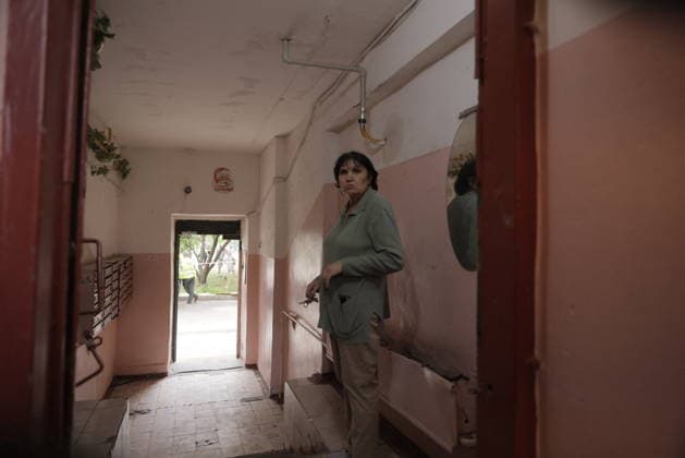 Russian Drone Strike On Residential Building - Kharkiv A woman walks through a residential building corridor with visible structural damage, including exposed piping and deteriorated walls, in Kharkiv, Ukraine, on August 9, 2026. The building sustained damage from drone strikes that targeted the Saltivka district, killing two people and injuring dozens of residents. Photo by Yevhen Titov ABACAPRESS.COM Kharkiv Kharkiv Oblast Ukraine  Copyright: xTitovxYevhen ABACAx