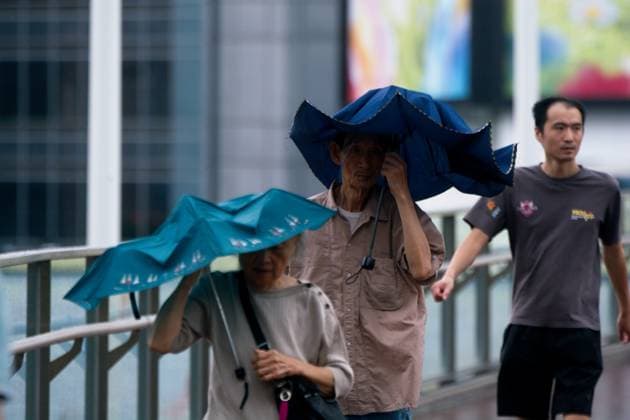 Typhoon Dolphin Arrives To Shanghai An elderly couple walks against strong winds at Xujiahui in Shanghai, China, as Typhoon Dolphin approaches the city. shanghai China  Copyright: xYingxTangx originalFilename: tang-typhoond260809_npOPb.jpg