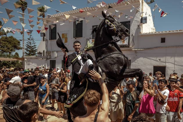 August 9, 2026, Llucmacanes, Menorca Balearic Islands, Spain: A caixer, or horse rider, rears his horse amid a cheering crowd during the traditional Jaleo at the Sant Gaieta Festival in Llucmacanes Llucmacanes Spain  - ZUMAo105 20260809_fap_o105_030 Copyright: xMatthiasxOesterlex