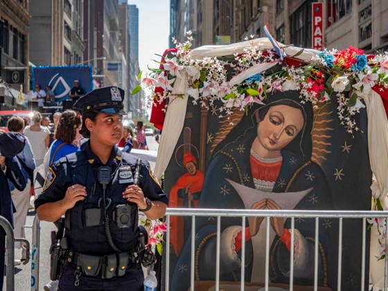 August 9, 2026, New York, New York, USA: A New York City police officer stands along the route of the 44th annual Dominican Day Parade on Sixth Avenue in New York. Held under the theme Identity and Culture, the parade featured colorful floats, traditional dance groups, and merengue and bachata music as thousands of participants and spectators celebrated Dominican heritage. New York USA  - ZUMAh156 20260809_znp_h156_021 Copyright: xMiloxHessx
