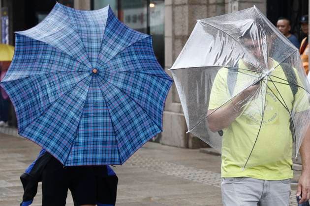 SHANGHAI, CHINA - AUGUST 09: Tourists with umbrellas walk in the rain along the Bund on August 9, 2026 in Shanghai, China. The Shanghai Meteorological Observatory upgraded the rainstorm warning signal for the central urban area from orange to red at 10:30 a.m. due to the impact of Typhoon Dolphin.  Copyright: xChinaxNewsxServicex 111658975356